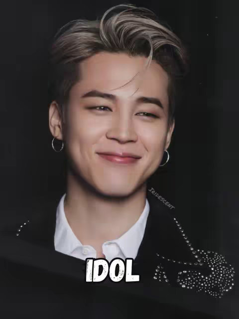 The cover image features a smiling man with platinum blonde hair and a black jacket embedded with rhinestones. Below his face, the word "IDOL" is written in bold white letters.