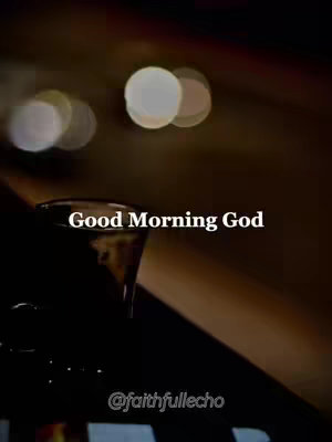 The image is a vertical shot with a blurred background of warm colors with lens flares. In the foreground, there's a dark silhouette of a glass (possibly a cup), and overlaid on the image, centered, is text with the words "Good Morning God" in a bold font. At the bottom is a watermark.