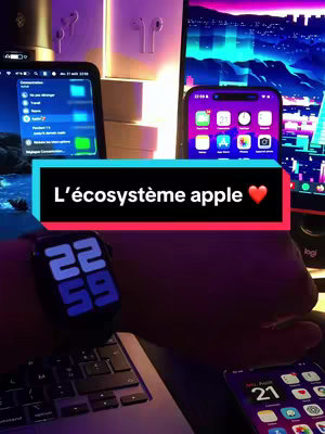 The image showcases an Apple ecosystem setup, featuring an iPhone, an Apple Watch displaying the time, and a laptop, along with a tablet. The image is shot with a dark, ambient lighting scheme with colorful neon accents.