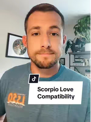 A man with short brown hair and a short beard is centered in the image. He wears a teal t-shirt and smiles slightly at the camera. A white overlay with the TikTok logo and the text "Scorpio Love Compatibility" is placed at his lower chest.