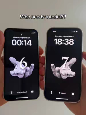 The image shows two smartphones, side by side, displaying lock screens. One screen shows the time and date, and the other displays a different time and date. Both screens have a black background, with a hand with an abstract design as the main element. The phones are held by two hands. The background seems minimalistic.