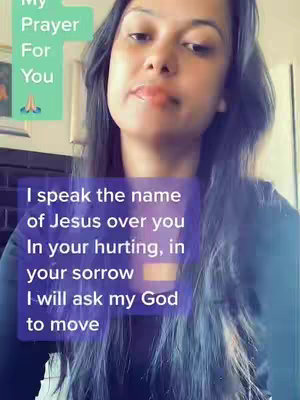A woman with long, dark hair is positioned in front of what appears to be an interior setting. Two text overlays are on the screen: one in a square shape in the upper-left corner that says, My Prayer For You, along with a graphic of hands in prayer. The second, larger text is a rectangle in the lower center of the screen in a purple background, containing a message about speaking the name of Jesus. The woman is looking slightly up towards the camera with a soft expression.
