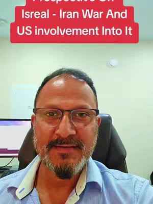 A man with glasses and a beard is centered, appearing to be in an indoor setting. Above his head, a red banner displays white text.