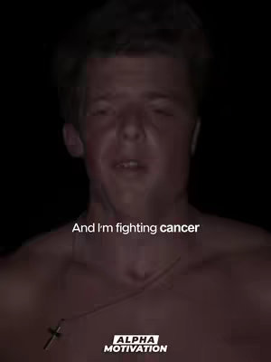 A shirtless young man with short hair is centered in the frame against a dark background. Text appears at the bottom, and a logo at the bottom right.