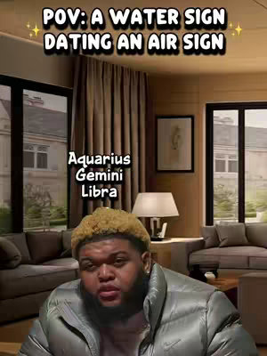 The cover image shows a man in a puffer jacket seated indoors with a blurred background. Above him, text overlayed in a stylized font reads 'POV: A WATER SIGN DATING AN AIR SIGN'. Below, the zodiac signs 'Aquarius, Gemini, Libra' are listed. The man gazes at the camera, in front of what seems to be a comfortable living room setting with a lamp, window and curtains.