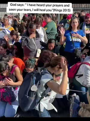 An image of a crowd of people in an outdoor setting, seemingly praying. The focus is on several individuals with hands raised and eyes closed. Text boxes are displayed with religious quotes, overlaying the picture. The scene includes individuals from diverse ethnic backgrounds in casual clothing. The background shows buildings and sky, suggesting an urban or public space.