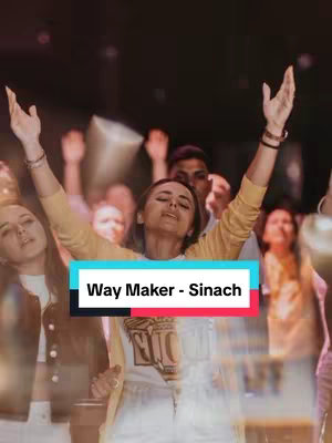 The image shows a group of people with their arms raised in worship in an indoor setting. A woman in the center with closed eyes has her arms raised towards the sky. Text overlaid on the picture says "Way Maker - Sinach".