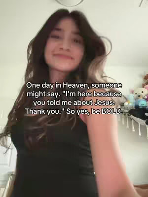 A woman is centered in the image, looking slightly upwards with a subtle smile. She has long, wavy dark hair framing her face. The background appears to be a room with a soft, diffused light, possibly from a window. Overlaid on the image is text arranged in a few lines.