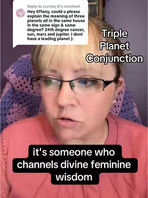 A woman with blonde hair and glasses is the main focus, set against a blurry backdrop of a purple patterned fabric and a wooden frame. The image is framed from the chest up, with text overlaying the image. The woman's facial expression is engaged as she speaks.