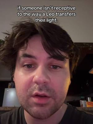 A close-up shot of a man's face against a blurry background. The man has dark hair and a beard. Overlay text is placed at the top. He appears to be speaking directly to the camera. The lighting is soft, with warmer tones on his face.