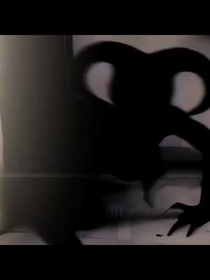 A dark, monochrome image showing a silhouetted demonic figure crouching near a wall. The figure has large horns and an elongated body. The background is dimly lit, suggesting a confined space. 