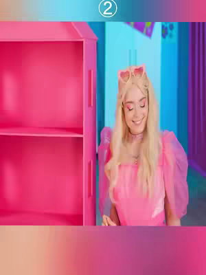 The cover image shows a woman dressed in a pink dress. She is smiling and posing in front of a pink cabinet and blue wall