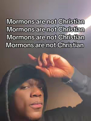 A selfie-style video with the creator in a hoodie. Overlayed at the top, repeated text in white font on black background: 'Mormons are not Christian,' four times. The creator is raising right index finger.