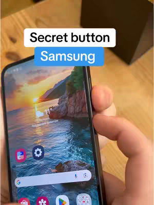 The cover image shows a close-up of a Samsung Galaxy phone held by a hand. The phone screen displays a landscape image with a sunrise over water. Text overlays indicate "Secret button" at the top and "Samsung" in a blue box below. The scene has warm lighting, and a wooden table is visible in the background.