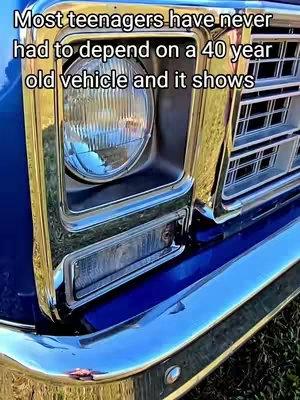 Close-up of a classic blue and chrome Chevy truck front end. The image focuses on the headlight, chrome grill, and bumper, with text overlayed at the top.