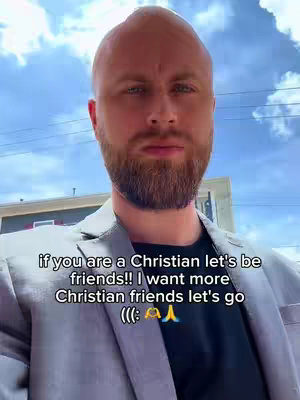 A man with a shaved head and a beard stands in front of a cloudy sky, the text overlayed.