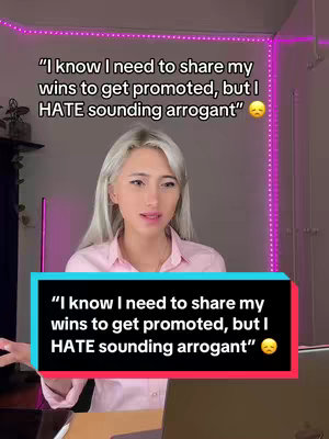 A woman with long, silver hair and a pink collared shirt is speaking to the camera. There's text overlays, one at the top and another at the bottom of the screen.