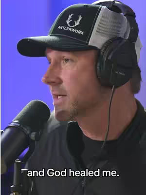 A man with a black cap with the name 'AntlerWorx' and a microphone speaking with a blue background