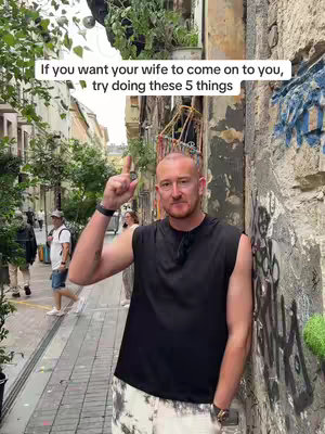 The cover image shows a man in a black sleeveless shirt with a city street in the background. The man is pointing up with one finger. Text overlay is at the top.