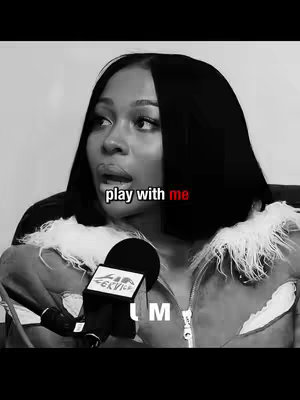 The image is a black and white close-up shot of a woman with short black hair looking slightly off-camera. She is wearing a jacket. The text overlay 'play with me' is written across the image in white text with the word 'me' in red. A microphone with the 'CK VICE' logo is visible in the foreground.