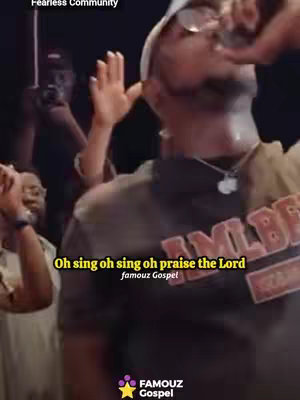 The cover image shows a man singing with his right hand raised. The text overlay reads: 'Oh sing oh sing oh praise the Lord' in a bold, yellow font and the text 'famouz Gospel' is below it. The man is wearing a black shirt and white hat, and there are others in the background with raised hands. The colors are warm, with a focus on the performer lit by stage lights.