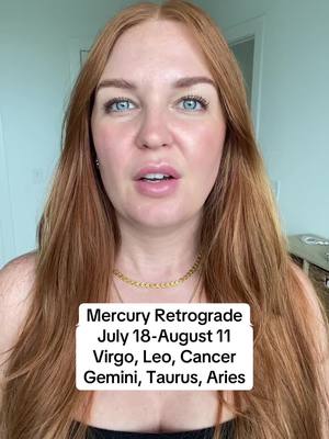 A woman with long auburn hair and fair skin looks directly at the camera with a neutral expression. She has blue eyes and is wearing a gold necklace. A white rectangle with black text is overlaid near her mid-chest area.