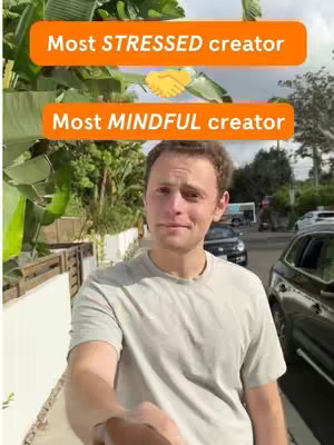 A selfie-style shot with a man in the foreground, a text overlay at the top of the image, and a neutral background with a street and parked cars.