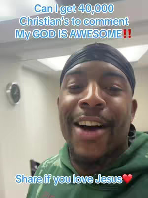 A selfie-style video cover image featuring a dark-skinned man with a close-up view. He's wearing a black durag and a green hoodie. The background is a generic white wall. Overlay text includes a request for Christians to comment and a call to share if they love Jesus.