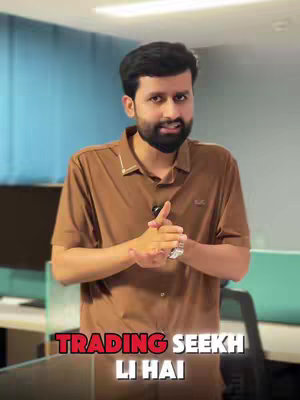 A man in a brown shirt stands with his hands clasped, looking toward the camera. The background is blurred, with hints of blue and teal, suggesting an office setting. Red text reads 'TRADING SEEKH LI HAI' at the bottom of the image.