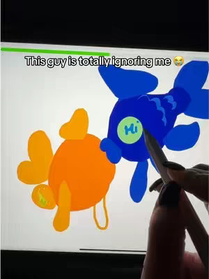 The cover image shows a digital art piece on a white canvas. Two cartoonish fish are depicted in bright colors: one orange and one blue. The orange fish is on the left, featuring a large, round body. The blue fish is on the right and larger, with a more complex, fin-like design. A hand with a black painted nail is holding a digital pen hovering by the fish. The hook text appears on the top which says "This guy is totally ignoring me", and the eye rolling emoji.