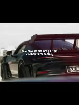 The image shows a black sports car speeding down a road, likely on a highway. The camera angle is from behind the car, offering a perspective of where the driver is. Overlayed text indicates the video's theme. The scene may be meant to convey a sense of success, power, or speed.