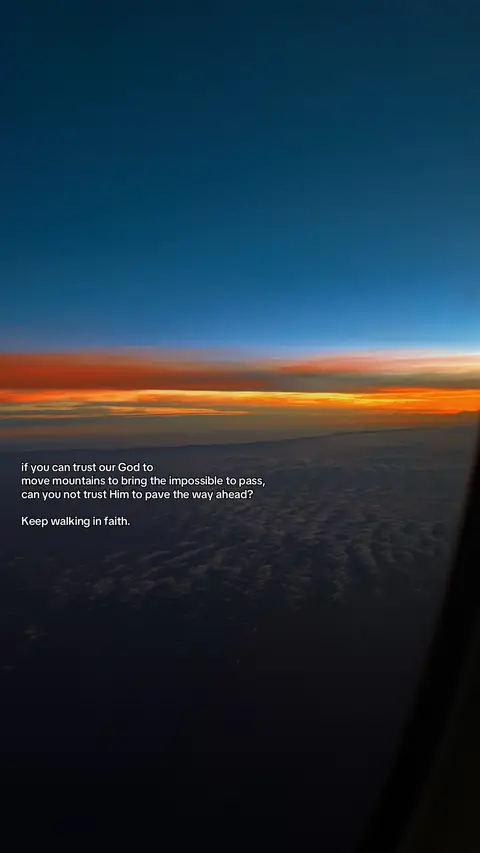 An aerial view captures a vibrant sunset over a layer of clouds. The sky transitions from deep blue at the top to orange and pink hues towards the horizon. Below, a sea of clouds stretches across the frame, catching the light and adding depth. Text in white font is overlayed, and a portion of the inside of the window is visible on the bottom right.