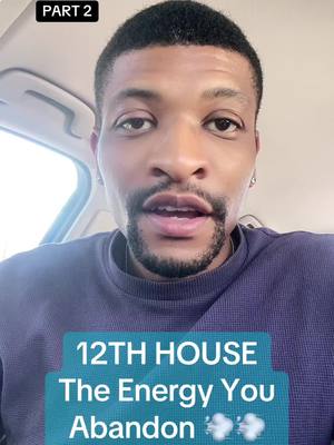 A frontal close-up shot of a Black man inside a car, looking directly at the camera. He has short, dark hair and a neatly trimmed beard and mustache. He's wearing a purple crew neck sweater. Below him, a turquoise box contains the text '12TH HOUSE' in white uppercase letters, followed by 'The Energy You' in a smaller sans-serif font, and then 'Abandon' in the same larger font. Two emoji clouds are added on the right.