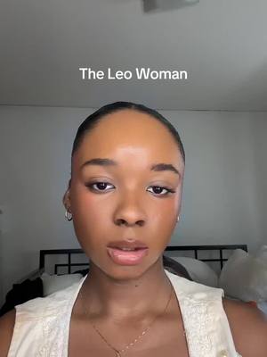 The image is a close-up of a woman's face. She has a neutral expression with her lips slightly parted. The text "The Leo Woman" is overlaid at the top of the frame.