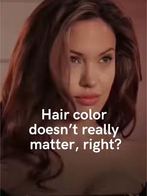 A close-up shot of a woman with long, wavy brown hair and a soft gaze looking slightly off-camera. Overlaid on the image is white text asking the rhetorical question, 'Hair color doesn't really matter, right?' The overall composition is warm-toned.