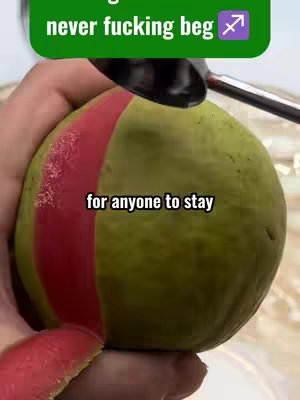 The image shows a green fruit with a red stripe being cut open with a knife or similar tool. It has overlaid text in the top and center of the image.