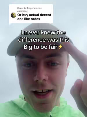 A selfie-style shot with a young man against a cloudy sky background. The man, with fair skin and light-colored hair, is wearing a light green hoodie and a gray baseball cap. Text overlayed at the top quotes a comment, and a larger text overlay in the middle says 'I never knew the difference was this Big to be fair' with a lightning bolt emoji. The man's face is the primary focus, with the foreground capturing his upper body, head, and shoulders. His expression is engaged and slightly smiling during the selfie shot.