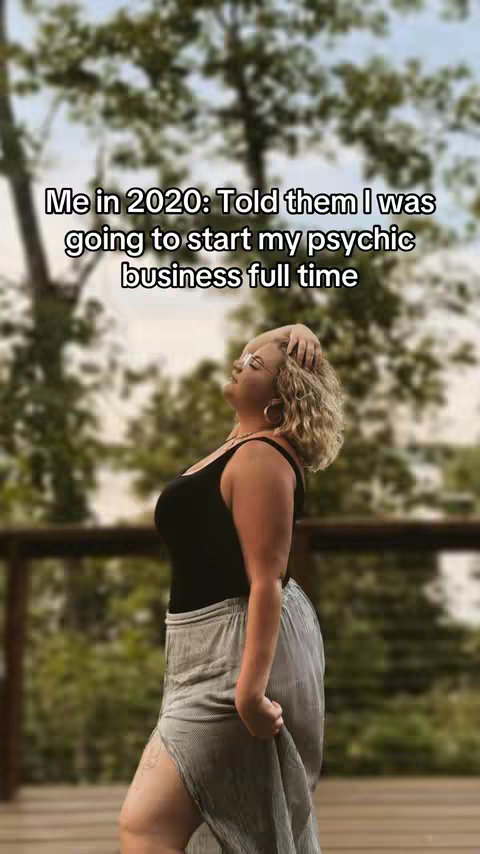 The image shows a woman standing on a wooden deck, looking upwards with her eyes closed and a hand in her hair. The background is blurred, with trees and foliage visible. Text is overlaid on the image.