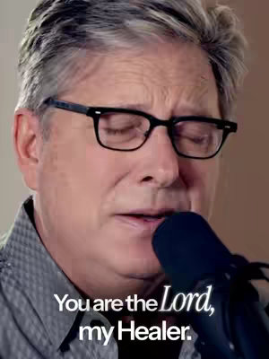 The cover image shows a close-up of a man wearing glasses, his eyes closed, likely singing or speaking into a microphone. His gray hair shows signs of age. The background is blurred, suggesting focus on him. Below him, text reads 'You are the Lord, my Healer.'