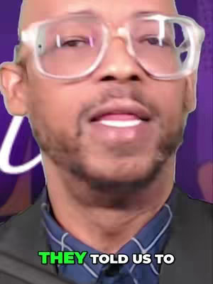 The cover image is a close-up shot of a man with a bald head and clear-framed glasses. The man's face fills most of the frame, with the top of his head cut off. He's looking slightly off-center and speaking. The background is blurred, with a purple color gradient. Overlayed at the bottom in a bright green text, reads "THEY TOLD US TO". The man is wearing a blue collared shirt under a dark blazer.