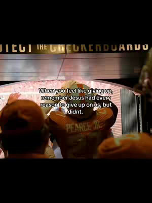 An image from a movie scene with text overlayed. The scene shows a man in an orange football uniform facing left, while a text overlay provides a motivational message set against what seems to be the interior of a stadium.