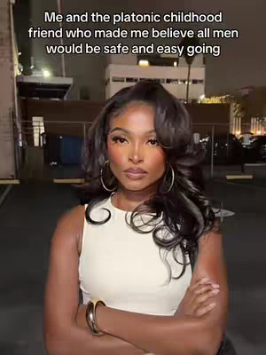 A woman with long dark hair, wearing a white sleeveless top and large hoop earrings, stands against a background of buildings at night. Text overlays the image.