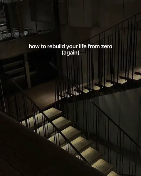 An eye-level shot of a complex staircase with numerous steps and landings. A textual overlay at the top of the image reads, "how to rebuild your life from zero (again)."