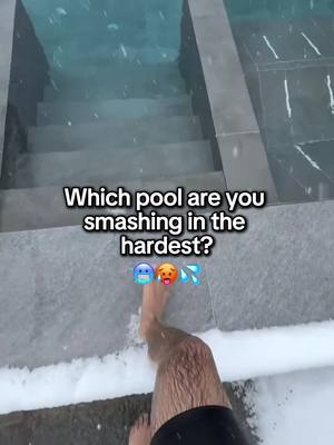 A person's legs, clad in black shorts, are seen entering an outdoor pool. The image is taken from the top looking down. The water is clear and cold, indicated by the snowy environment. Text overlay asks 'Which pool are you smashing in the hardest?'