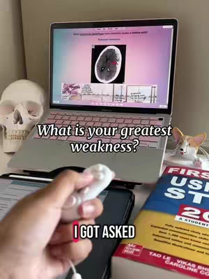 The cover image shows a desk setup with a laptop displaying medical information in the background, and a detached white controller in the foreground being held. A model skull, a book, and a small cat figurine are also visible.