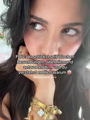 A selfie-style shot showing a woman with dark hair looking slightly off-camera. On the lower left of the image is her hand. The woman appears to be wearing light makeup with a neutral color palette. Text in the image reads, "POV: you schickst seit Wochen Bewerbungen, aber niemand antwortet dir... und du verstehst endlich warum".