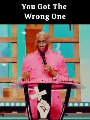 The cover image shows a man in a pink suit speaking into a microphone behind a podium. Above him, a black banner reads 'You Got The Wrong One'. The man is the central focus, with a background that appears to be a mix of wood panels and turquoise. The podium features a hand holding fist graphic.