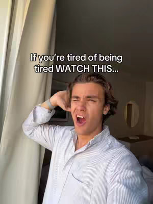 A young man in a light-colored striped shirt is yawning widely, head tilted back, with one hand resting on his head. Text overlay reads: If you're tired of being tired WATCH THIS...