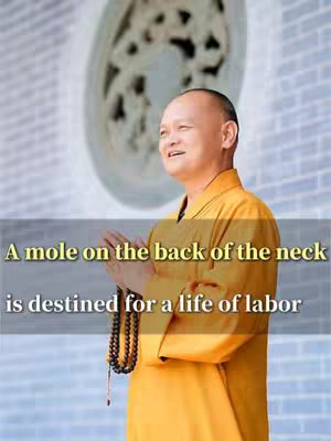 A man in a yellow robe stands, hands clasped in prayer, with the text overlayed, and a large, pale, decorative structure in the background.
