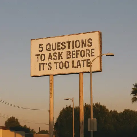 An outdoor shot features a large square sign with the text '5 QUESTIONS TO ASK BEFORE IT'S TOO LATE' in bold, black letters. The sign is mounted on two wooden posts and stands in front of a backdrop of a clear, light blue sky. Below the sign, the tops of some leafy green trees are visible.